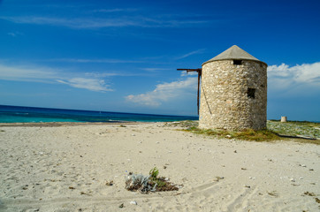 Fototapeta na wymiar windmill in lefkada island ai giannis beach summer in greece