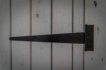 White rustic wooden door with rusty black iron