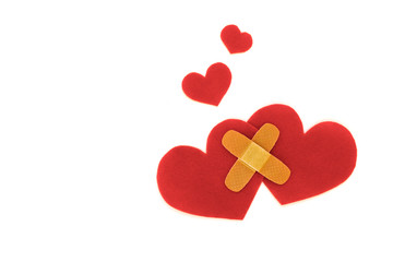 Two red hearts symbol with medical patch on white background, love concept. forgiveness