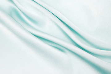 The texture of the satin fabric of blue color for the background