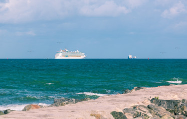 .Miami, FL, USA - March 29, 2019: Cruise Ship departing from Miami Port. The city is a famous tropical destination for cruises.View from South Point  Park Pier.