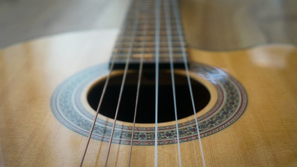 Obraz premium Guitar strings over sound hole