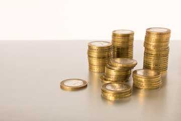 Stacks of coins on a light background. Business concept and growth of capital.