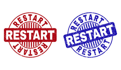 Grunge RESTART round stamp seals isolated on a white background. Round seals with grunge texture in red and blue colors. Vector rubber overlay of RESTART tag inside circle form with stripes.