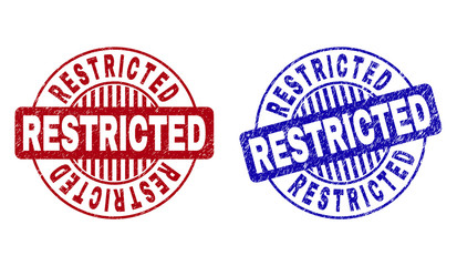 Grunge RESTRICTED round stamp seals isolated on a white background. Round seals with grunge texture in red and blue colors. Vector rubber watermark of RESTRICTED title inside circle form with stripes.