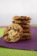 Tower of delicious cookies with chocolate chips, one of them outside the group
