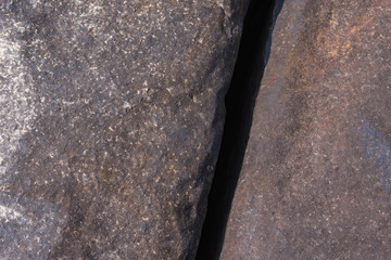 The currents erode the rock until breaking.