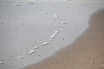 Bubble Foam of Sea Wave on the sand Beach
