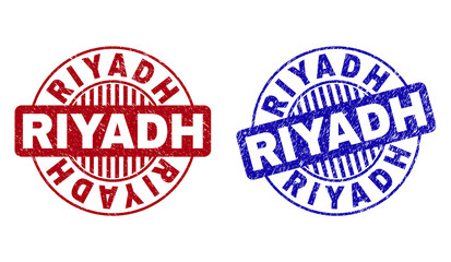 Grunge RIYADH round stamp seals isolated on a white background. Round seals with grunge texture in red and blue colors. Vector rubber overlay of RIYADH tag inside circle form with stripes.