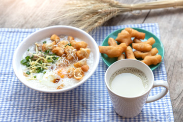 Breakfase meal. Congee or Rice porridge minced pork, boiled egg with soy milk and Chinese deep fried double dough stick