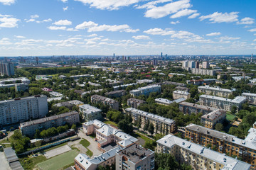 Fototapeta na wymiar Top down aerial drone image of a Ekaterinburg city in the midst of summer, backyard turf grass and trees lush green.