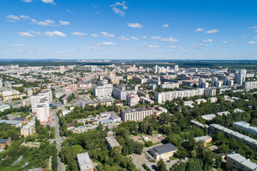 Top down aerial drone image of a Ekaterinburg city in the midst of summer, backyard turf grass and trees lush green.