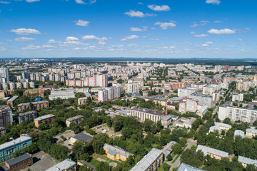 Top down aerial drone image of a Ekaterinburg city in the midst of summer, backyard turf grass and trees lush green.