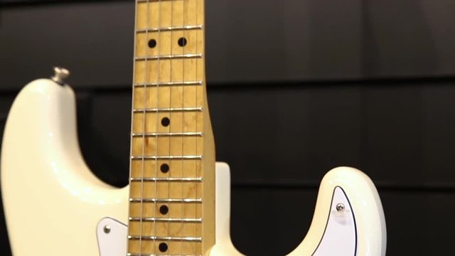 Professional white electric guitar, bottom-up movement