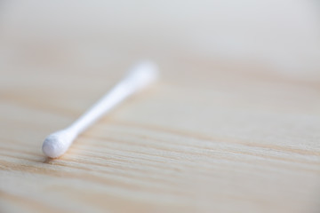 One white plastic cotton buds on wood table texture background, Close up & Macro shot, Selective focus, About Cleaning Body, Healthcare concept