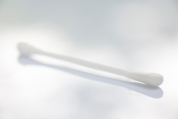 One white plastic cotton buds on white table texture background, Close up & Macro shot, Selective focus, Light & shadow, About Cleaning Body, Healthcare concept