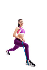 Beautiful young  woman doing lunge exercisewith sport fitness rubber bands  in fitness gym isolated over white background. Fit girl living an active lifestyle