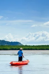 Foto op Canvas Man draging kayak on mud land of Tung Yee Peng mangrove. Krabi - Thailand © PixHound