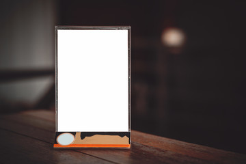 Close up empty mock up menu frame standing on wooden table in cafe. copy space for text.