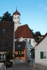 Harburg Germany, street scene in village with church clock tower in background in afternoon light