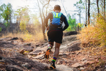 A man Runner of Trail . and athlete's feet wearing sports shoes for trail running in the forest