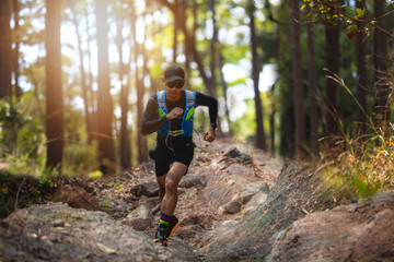 A man Runner of Trail . and athlete's feet wearing sports shoes for trail running in the forest