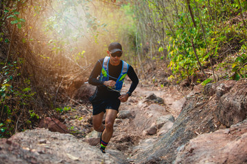 A man Runner of Trail . and athlete's feet wearing sports shoes for trail running in the forest © tuiphotoengineer