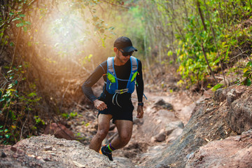 A man Runner of Trail . and athlete's feet wearing sports shoes for trail running in the forest
