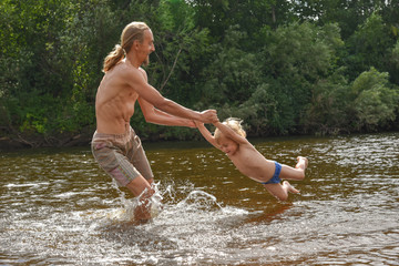 father teaching his little son to swim, they are happy.