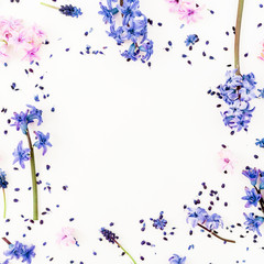 Pattern made of blue or pink flowers and petals on white background. Flat lay, top view.