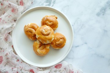 Close up of Singapore cookie on white plate.