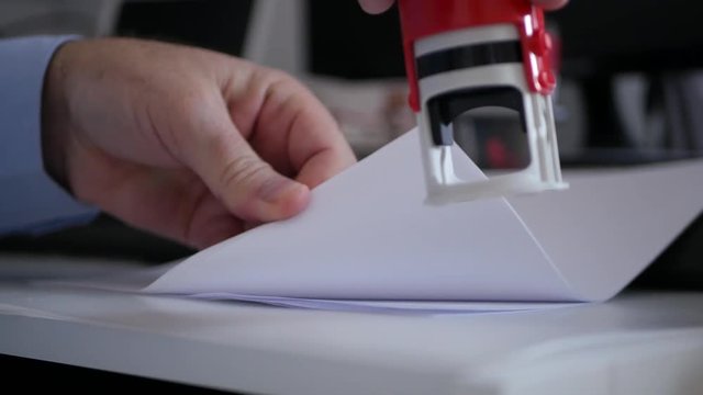 Businessman in Office Room Stamping Official Company Documents and Contracts