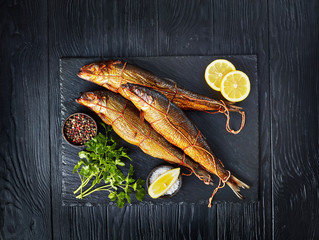 hot smoked herrings on a slate tray