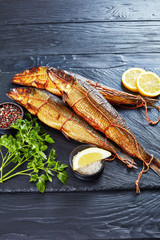 hot smoked herrings on a slate tray