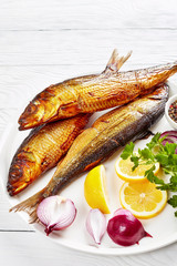 hot smoked herrings on a white plate