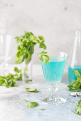 Colorful refreshing summer drink with basil seeds on light background.