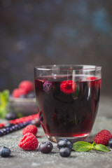 Berry drink with fresh blueberries and raspberries, berry ice lemonade in a glass