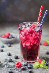 Berry drink with fresh blueberries and raspberries, berry ice lemonade in a glass