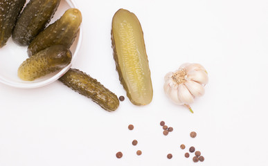Marinated pickled cucumbers in bowl. Top view, white background