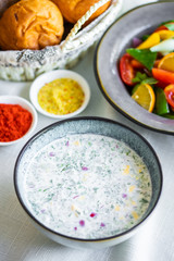 Traditional Russian summer cold soup. Russian breakfast. okroshka with salad and bread