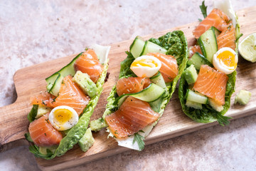Lettuce wrapped smoked salmon tacos with fresh cucumber, avocado and quail eggs