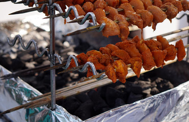 Indian street food vendor make Non vegetarian kababs or kebabs on charcoal flames