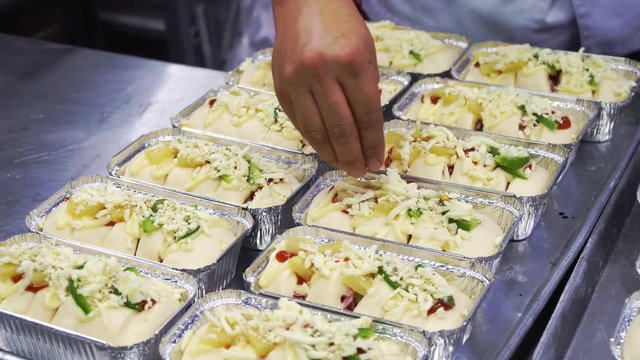 Chefs are sprinkling toppings on toast, ham pizza on a tray Freud.