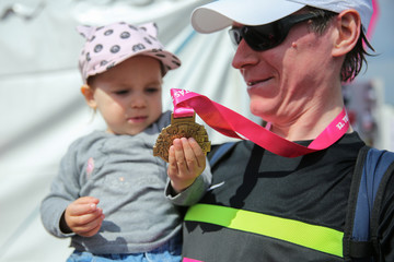 Father showing daughter his medal after 32nd Telekom Vivicitta Spring Half Budapest International Marathon in Budapest.