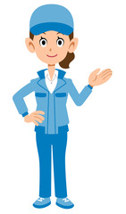 案内するベージュの作業着の女性