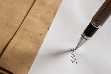 pen with signature and document in background