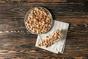 Obraz na płótnie Canvas Tasty sugared nuts on wooden table