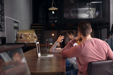 Young colleagues during coffee break in cafe