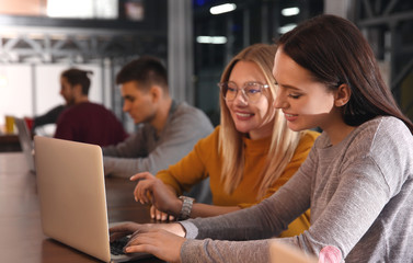Young colleagues during coffee break in cafe