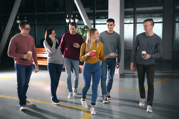 Young colleagues in lobby during coffee break